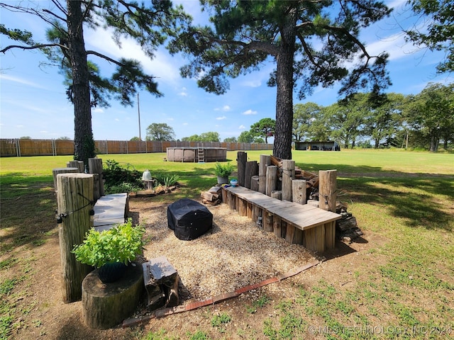 view of yard featuring fence and an outdoor pool