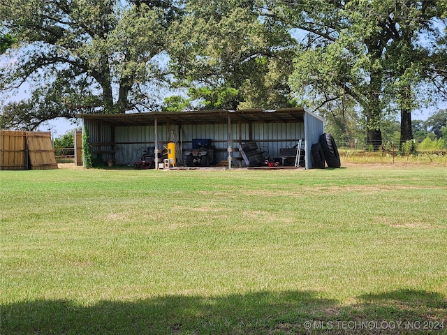 exterior space featuring a carport, an outbuilding, and fence