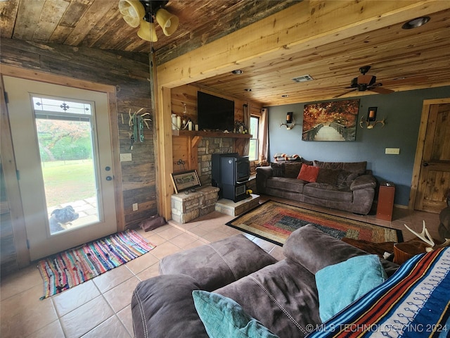 living room featuring ceiling fan, light tile patterned flooring, and wood ceiling