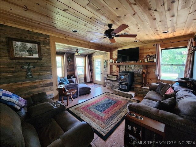 living room with ceiling fan, wooden ceiling, wood walls, and tile patterned floors