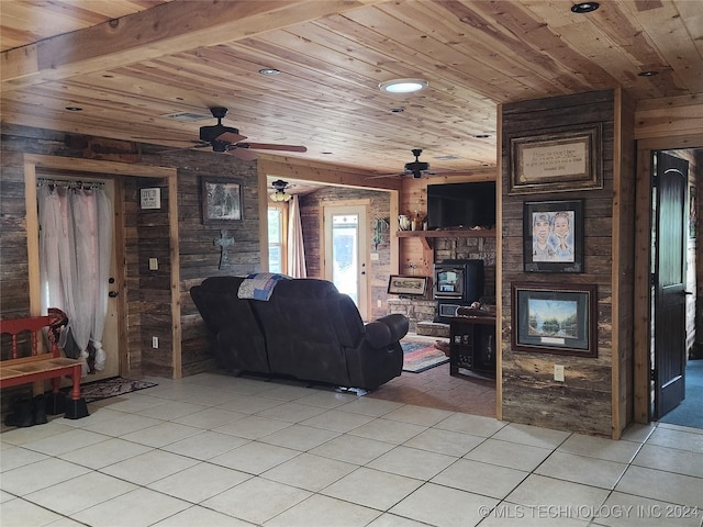 living room featuring beam ceiling, wood walls, wooden ceiling, and light tile patterned flooring