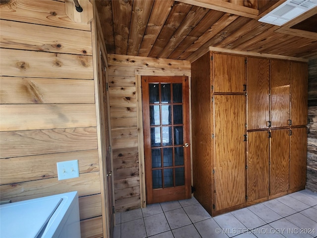 interior space with tile patterned flooring, wood ceiling, and wooden walls