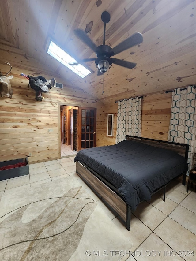 bedroom featuring wooden ceiling, visible vents, wooden walls, and light tile patterned floors