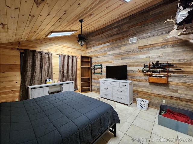 bedroom with lofted ceiling, visible vents, wood ceiling, light tile patterned flooring, and wood walls