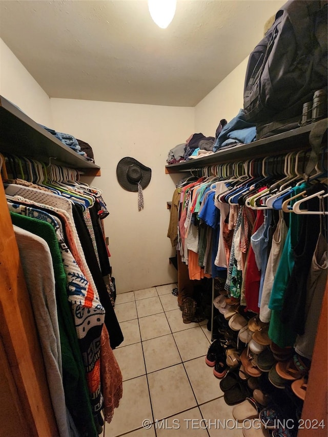 spacious closet with light tile patterned floors