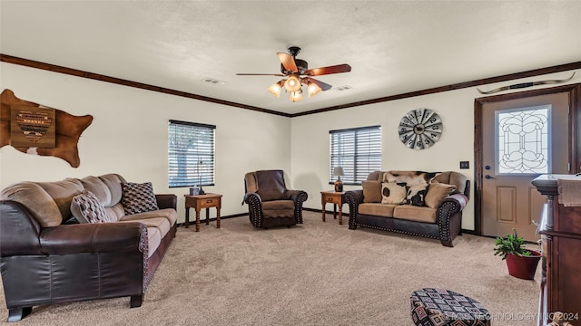 carpeted living room featuring a textured ceiling, ceiling fan, and crown molding