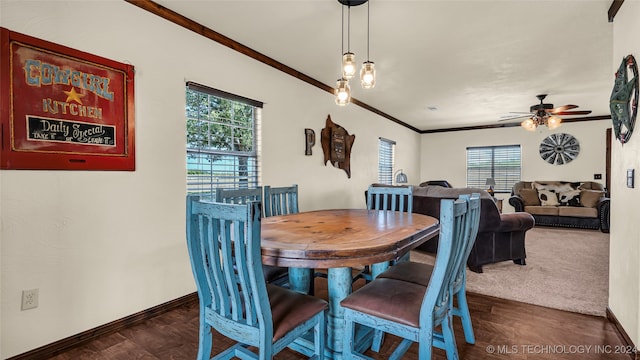 dining room with dark hardwood / wood-style flooring, ceiling fan, and crown molding