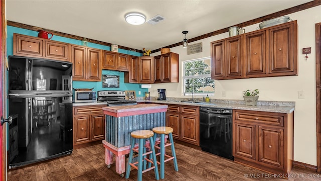 kitchen featuring dark hardwood / wood-style flooring, light stone counters, crown molding, sink, and black appliances