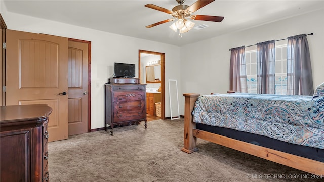 bedroom with ensuite bathroom, ceiling fan, and light colored carpet