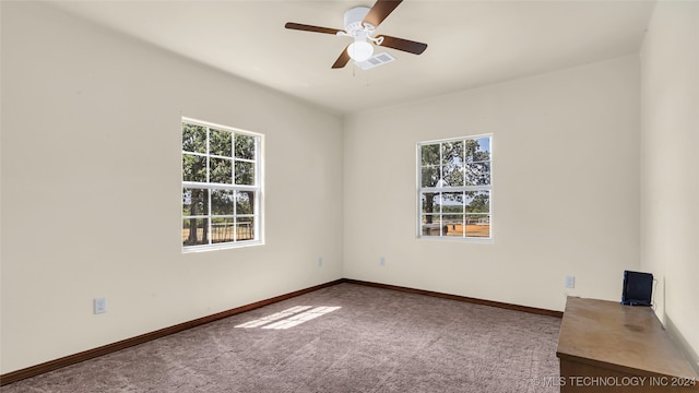 carpeted empty room featuring ceiling fan