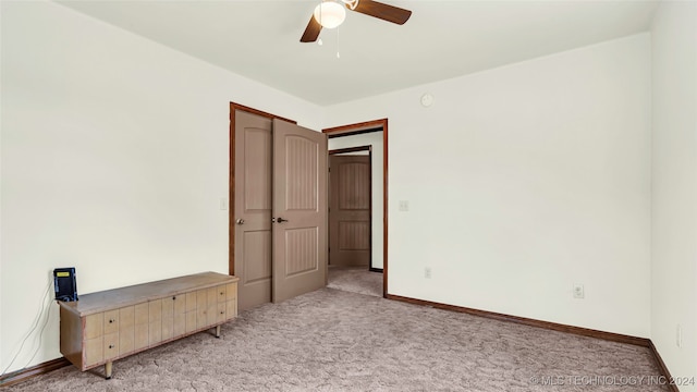 unfurnished bedroom with light carpet and ceiling fan