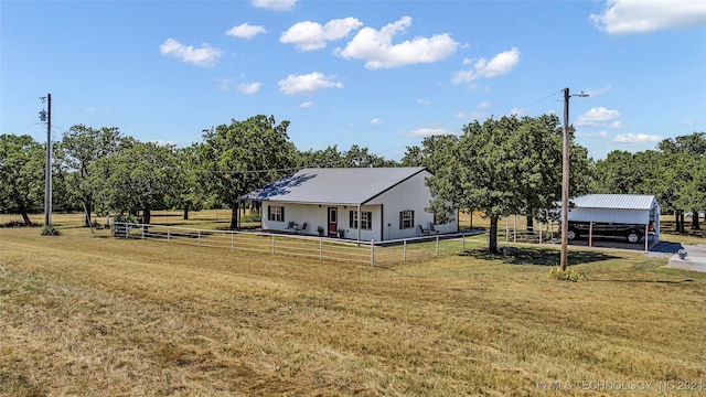 view of front of home with a front yard and a carport