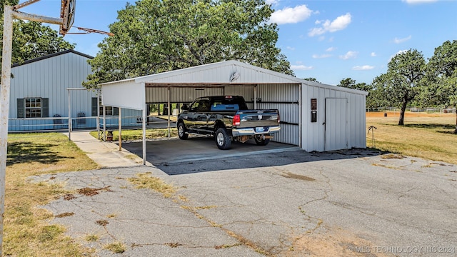 view of car parking with a carport and a yard