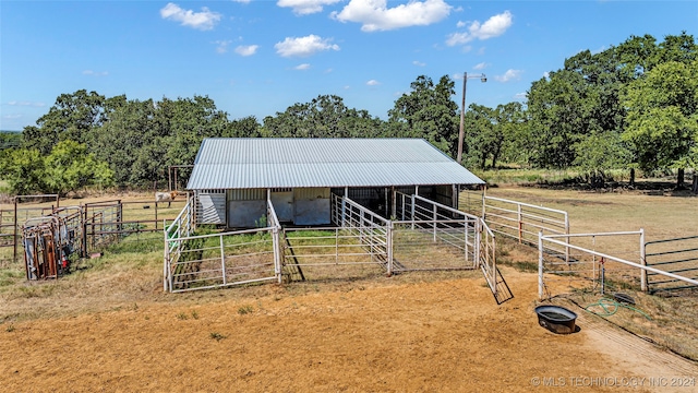 view of horse barn with a rural view