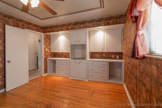 kitchen featuring ceiling fan, backsplash, light wood-type flooring, and white cabinets