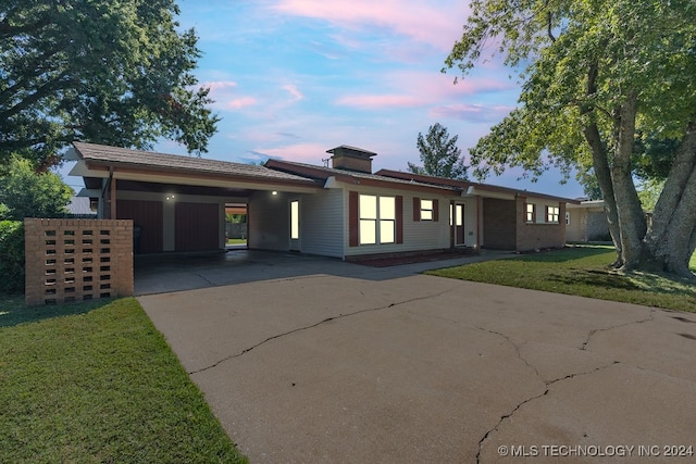 view of front facade with a yard and a carport