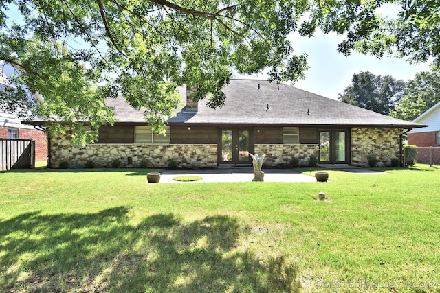 back of house with a yard and a patio area