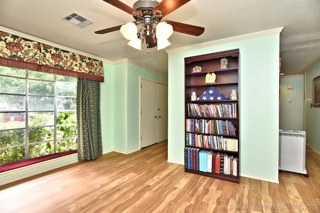 spare room with ornamental molding, ceiling fan, and light hardwood / wood-style floors