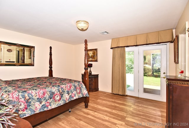 bedroom with light wood-type flooring and access to outside