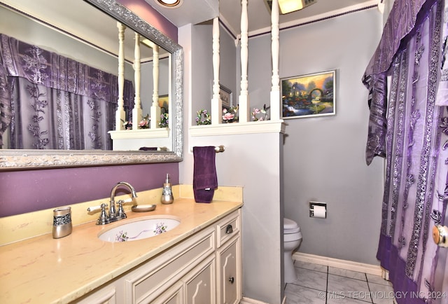 bathroom featuring vanity, toilet, and tile patterned floors