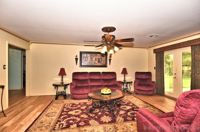 living room featuring hardwood / wood-style floors, ceiling fan, crown molding, and french doors