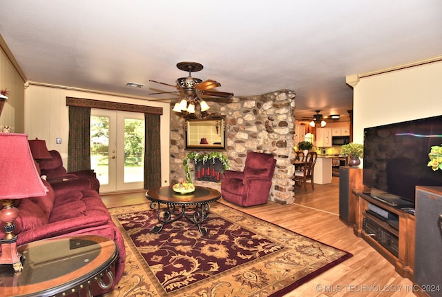 living room with french doors, ceiling fan, and light hardwood / wood-style floors