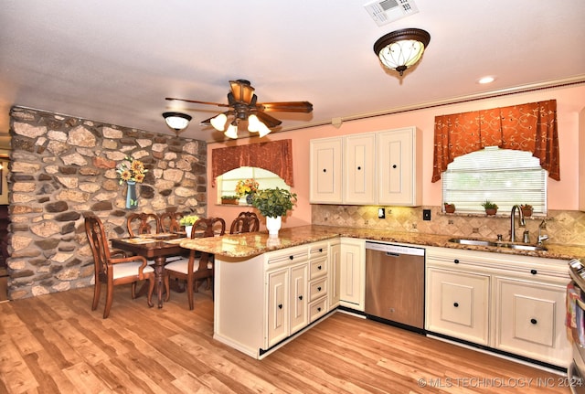 kitchen with light wood-type flooring, ceiling fan, dishwasher, and stone countertops