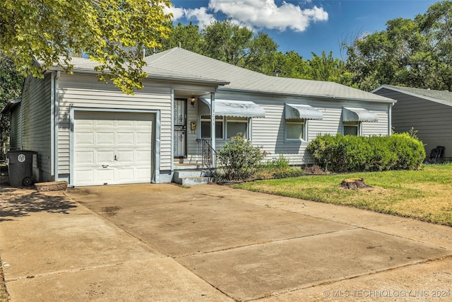 ranch-style home with a front yard and a garage