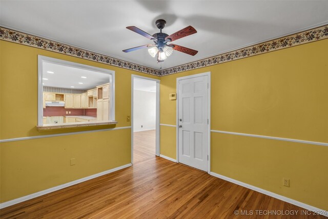 spare room with ceiling fan and light wood-type flooring