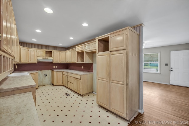 kitchen featuring ceiling fan, sink, light hardwood / wood-style flooring, and light brown cabinetry