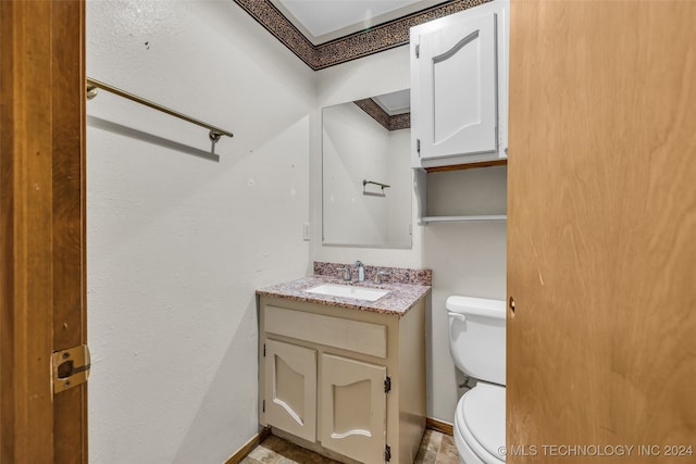 bathroom featuring tile patterned floors, crown molding, vanity, and toilet