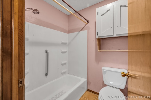 bathroom featuring toilet, shower / bathtub combination, and tile patterned floors