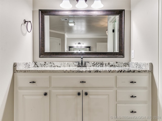 bathroom with vanity and ornamental molding