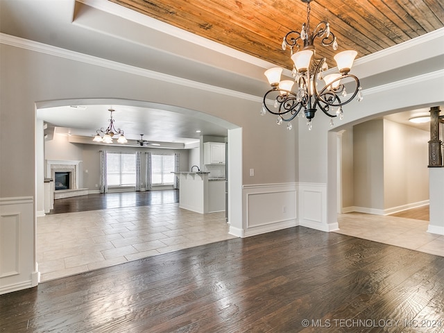 interior space featuring wood ceiling, a tray ceiling, tile patterned flooring, and ceiling fan with notable chandelier