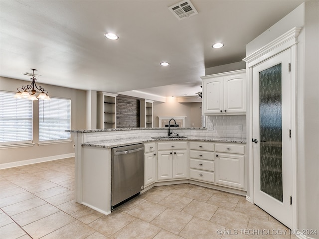 kitchen with decorative backsplash, stainless steel dishwasher, white cabinets, light tile patterned floors, and sink