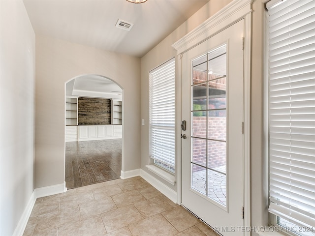 entryway featuring built in features and light tile patterned floors