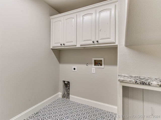 clothes washing area with electric dryer hookup, cabinets, hookup for a washing machine, light tile patterned floors, and gas dryer hookup