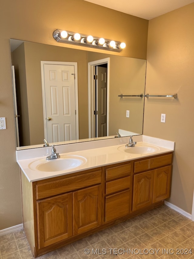 bathroom with dual bowl vanity and tile patterned floors