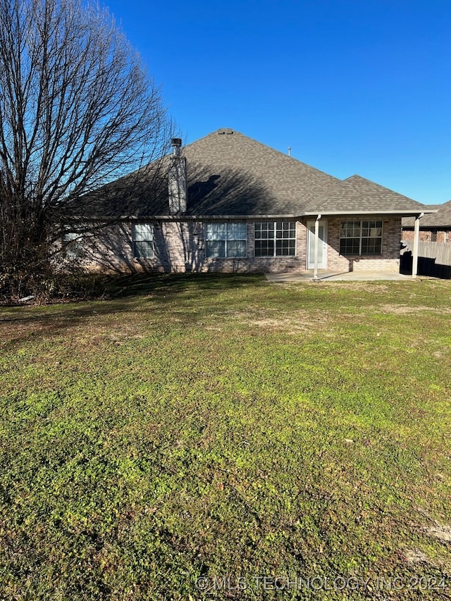 back of house featuring a yard