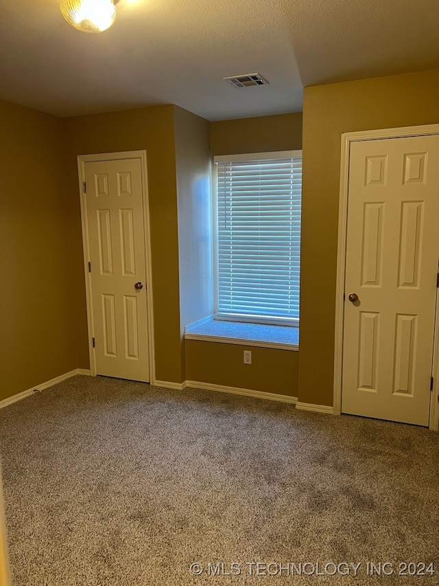 empty room with carpet flooring