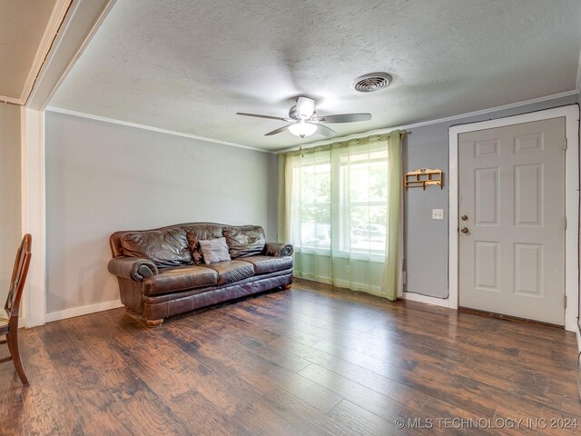 living room featuring ceiling fan, crown molding, a textured ceiling, and hardwood / wood-style flooring