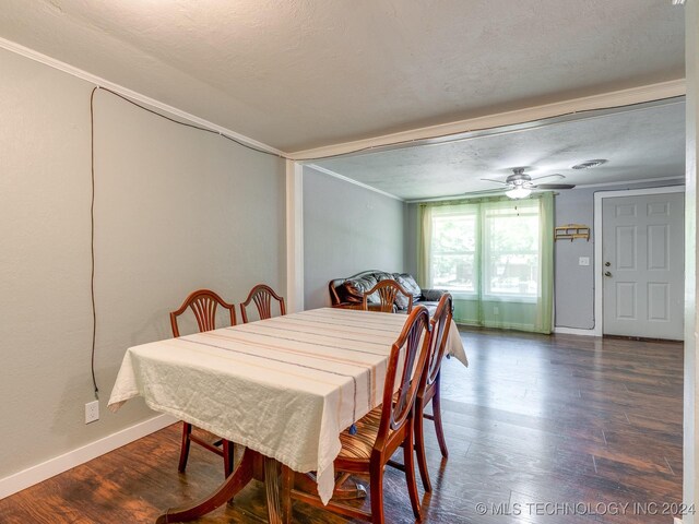 dining room featuring crown molding, ceiling fan, dark hardwood / wood-style flooring, and a textured ceiling