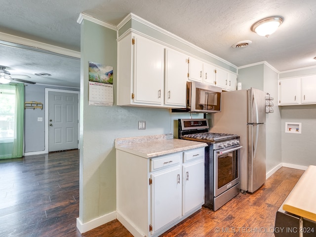 kitchen featuring ceiling fan, dark hardwood / wood-style floors, stainless steel gas range, and white cabinets