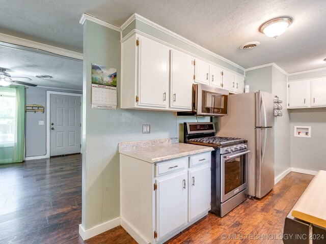kitchen with white cabinetry, ornamental molding, and stainless steel appliances