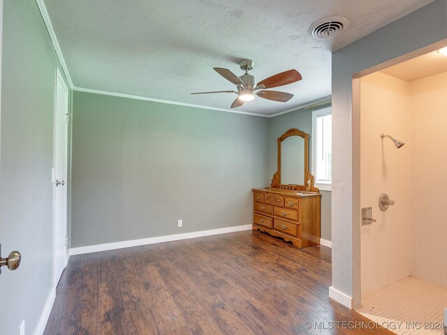 unfurnished bedroom featuring ornamental molding, dark wood-type flooring, ceiling fan, and a textured ceiling