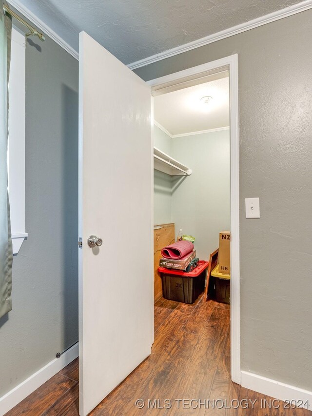 spacious closet with dark hardwood / wood-style flooring
