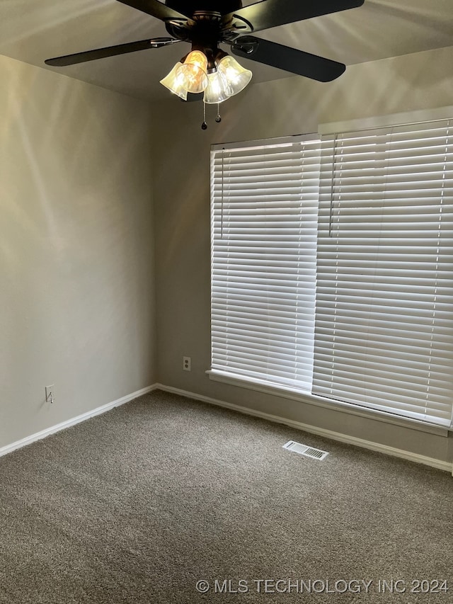 carpeted empty room with ceiling fan