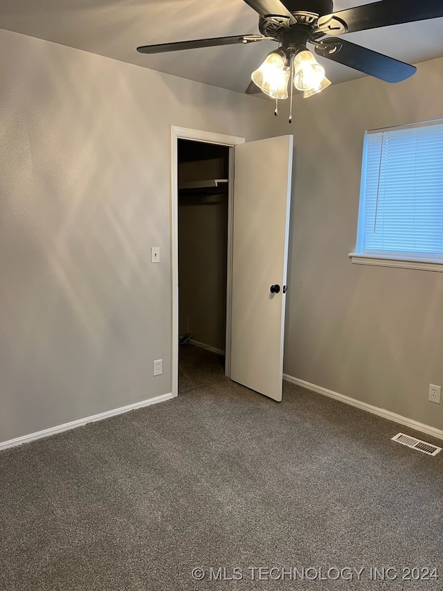 unfurnished bedroom with ceiling fan, a closet, and carpet flooring