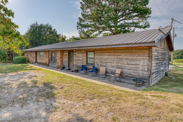 exterior space with a patio and a lawn