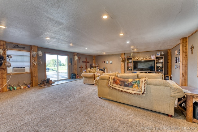 living room featuring cooling unit, light colored carpet, and a textured ceiling